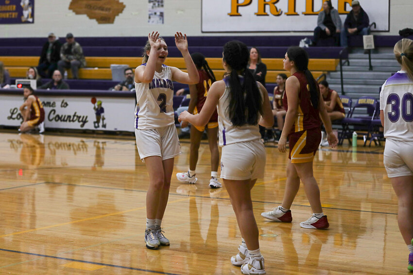 Leah Hamilton high-fives Kaiyah Sandridge after Sandridge drew a foul during Onalaska's win over Winlock on Jan. 11.