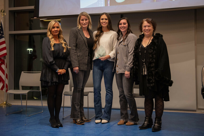 Coralee Taylor and Cynthia Mudge of the Centralia-Chehalis Chamber of Commerce stand with Lewis County Coffee Co. representatives Samantha Magnuson, Angie Twining and Nicole Butler at the chamber's annual banquet at Centralia College on Friday, Jan. 19.