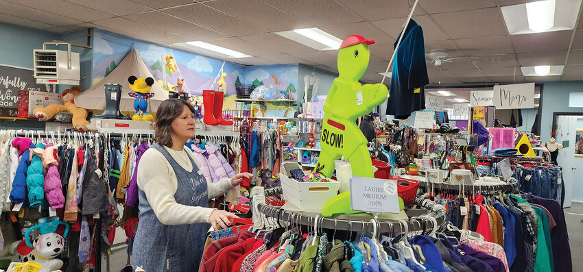 Brooke Neilsen peruses a clothing rack of consigned gently used clothing saved from going to the landfill.