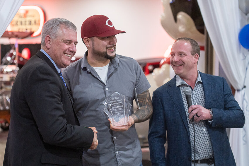 Confederated Tribes of the Chehahlis Reservation Chairman Dustin Klatush, center, smiles after being awarded the Russ Mohney Recreation Resource Stewardship Award during the Economic Alliance of Lewis County&rsquo;s annual banquet at Jester&rsquo;s Auto Museum on Friday, Feb. 2. He&rsquo;s pictured with Economic Alliance of Lewis County Executive Director Richard DeBolt, left, and Chronicle owner and Publisher Chad Taylor.
