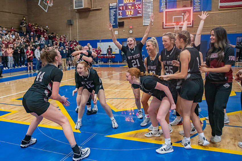 The Bearcats celebrate after W.F. West's District Championship win over Columbia River on Feb. 16. in Kelso.