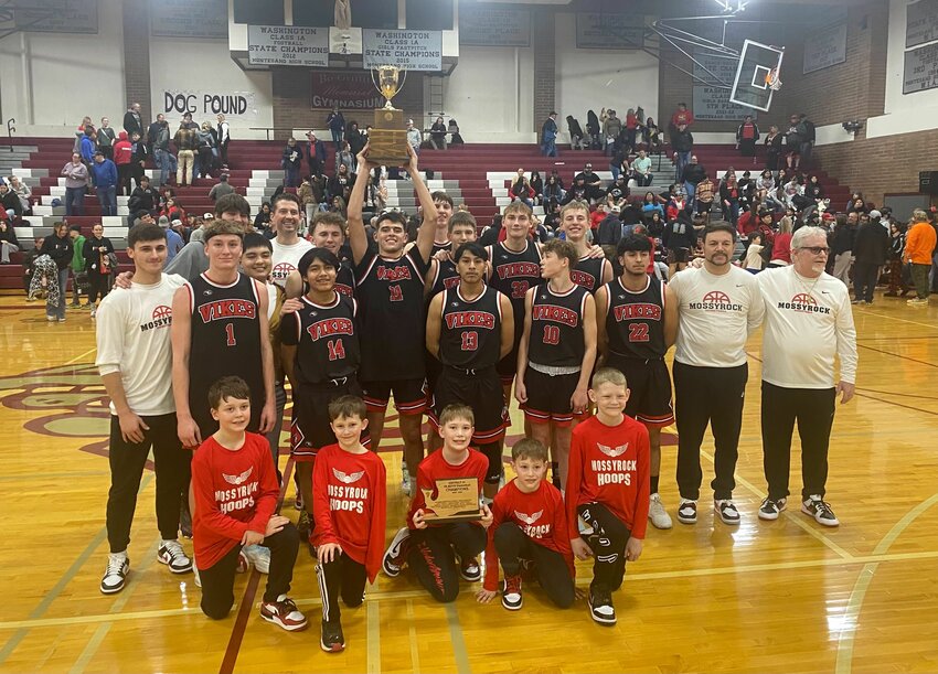 The Mossyrock boys basketball team poses with the District Championship trophy after defeating Naselle 79-35 in the 1B District 4 title game at Montesano on Feb. 17.
