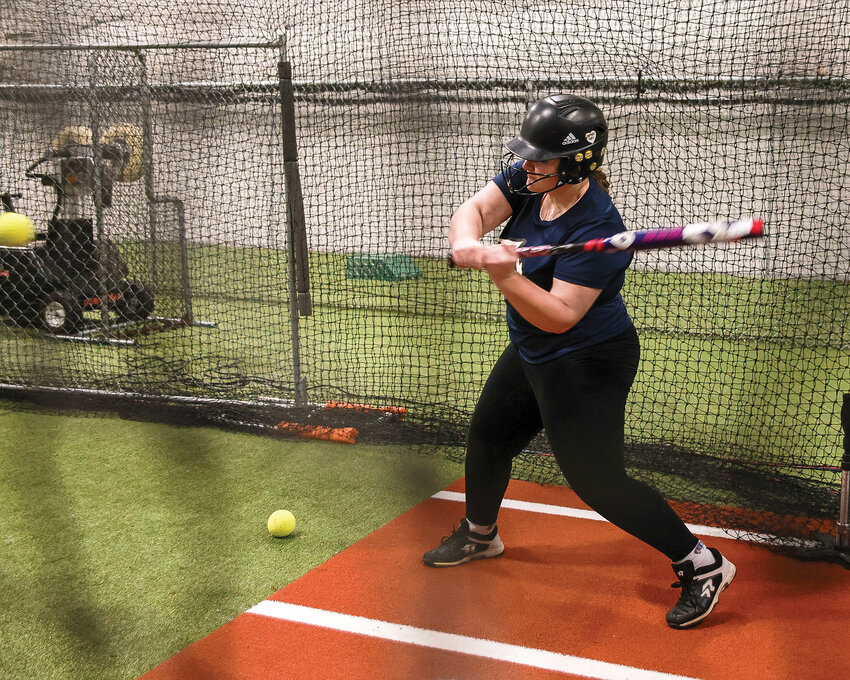 Battle Ground eighth grader Kenzie Kuhnhausen works on her softball skills at Strike Zone Batting Cages.