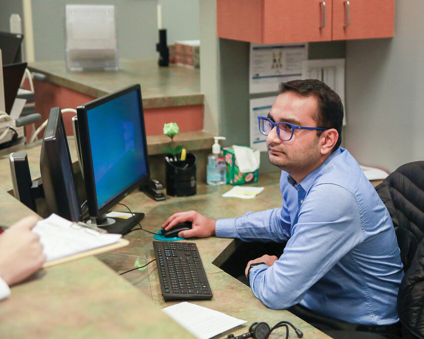 Second-year internal medicine resident physician Yash Patel listens to a nurse at Battle Ground HealthCare about a patient he is about to see on Monday, Feb. 12.