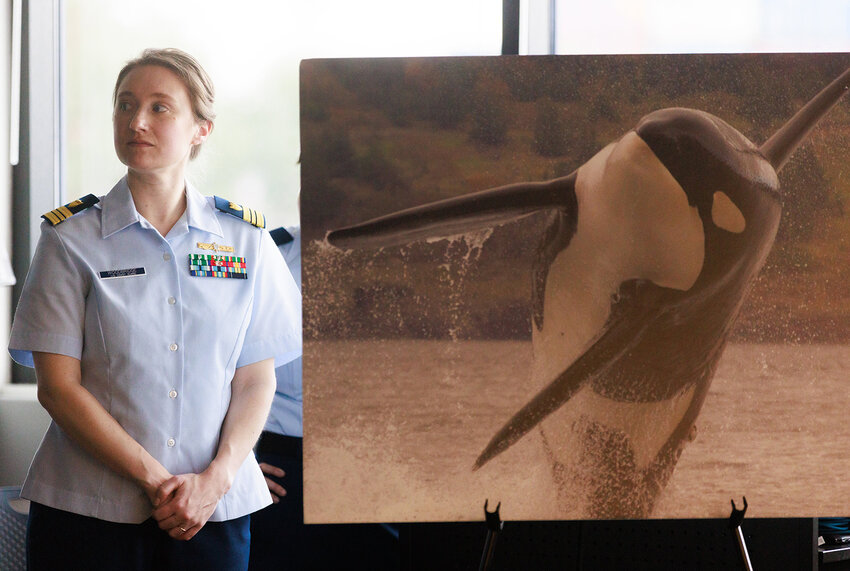 Lt. Commander Margaret Woodbridge listens during a press conference about the Coast Guard's new &quot;Whale Desk&quot; traffic alert system in Seattle February, 21, 2024.