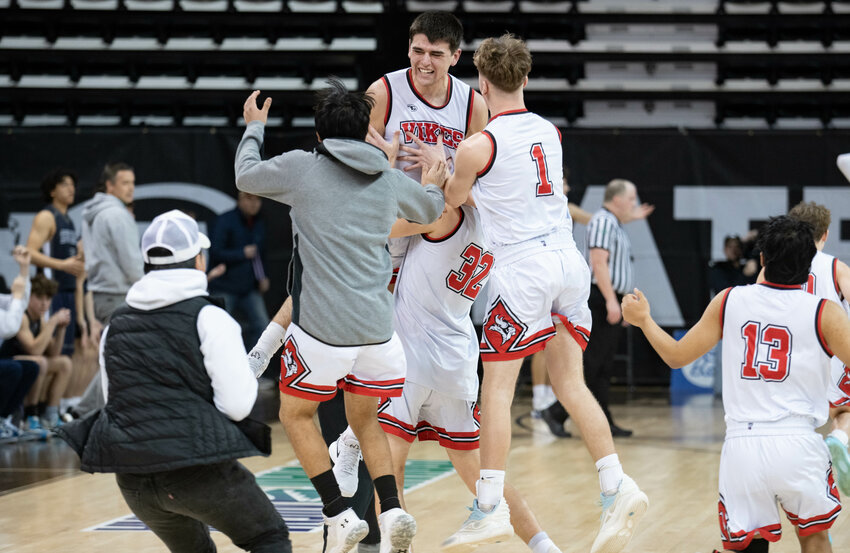 Zack Munoz celebrates with teammates after Mossyrock's win over Summit Classical Christian in the 1B Tournament Round of 12 on Feb. 28. at the Spokane Arena.