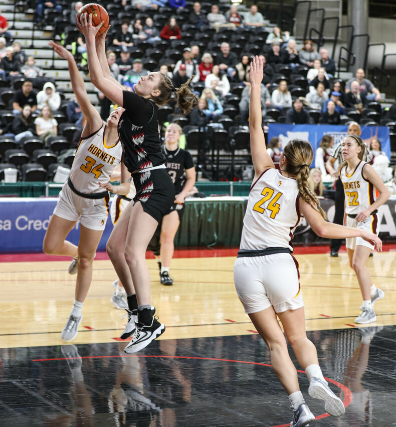 W.F. West's Julia Dalan takes a shot while defended by White River's Vivian Kingston (34) during Friday's Class 2A elimination game in Yakima.