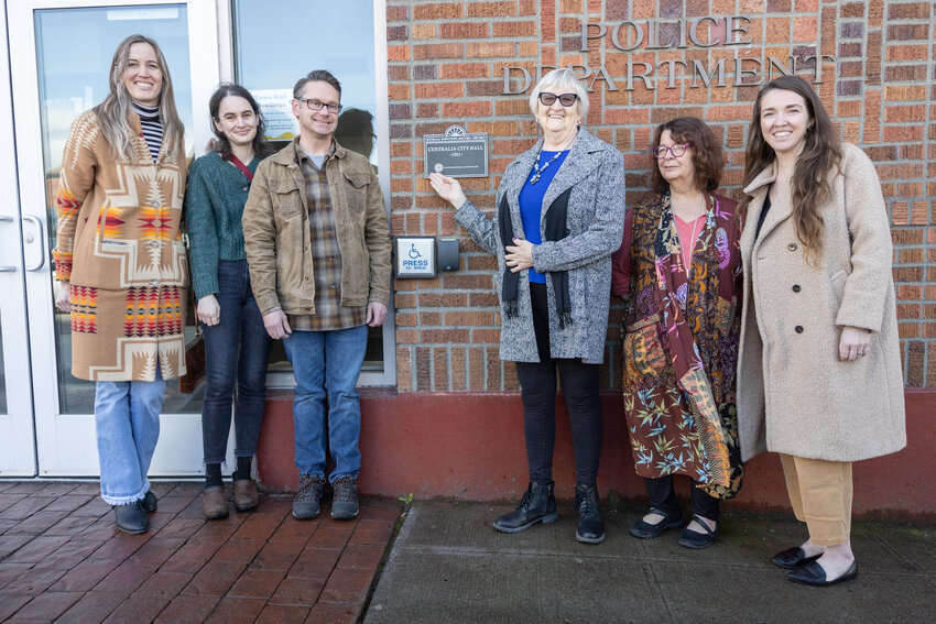From left: Centralia City Councilor Sarah Althauser, Kenza Abtouche, Lewis County Historical Museum Executive Director Jason Mattson, CDA members Edna Fund and Jan Nontell, and CDA Executive Director MacKenzie McGee pose for a picture with the new plaque at Centralia City Hall on Tuesday, March 12.