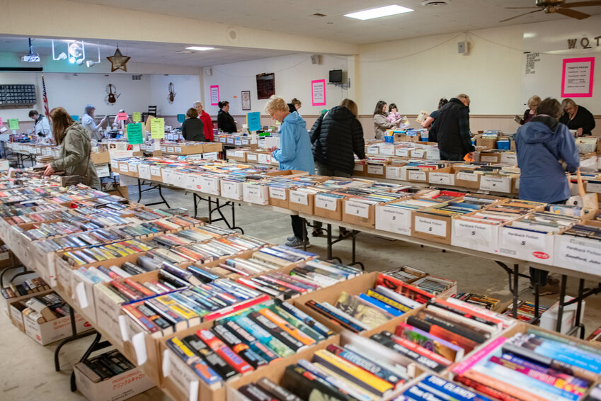 Crowds of people browse the selection of over 18,000 books for sale at the Lewis County American Association of University Women (AAUW) used book sale at the Moose Lodge in Centralia on Thursday, March 21.