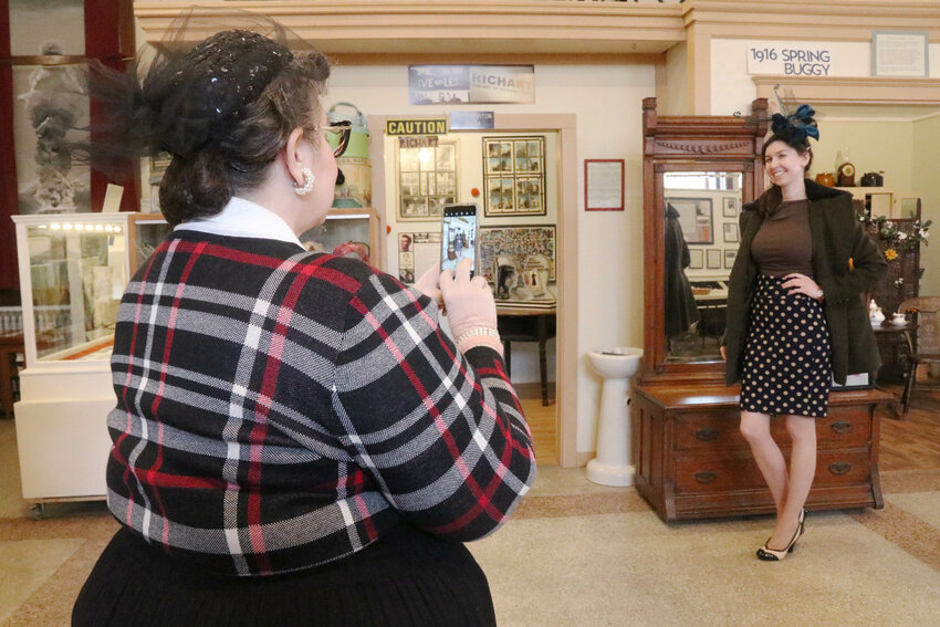 Lewis County Historical Museum Board Member Sara Light-Waller takes a photo of Madeline Elliott in her new fascinator in Chehalis on Saturday, March 23.  The workshop, where  participants were guided through the process of making a decorative fascinator headpiece, was organized by the museum and by The Shady Lady in Centralia.