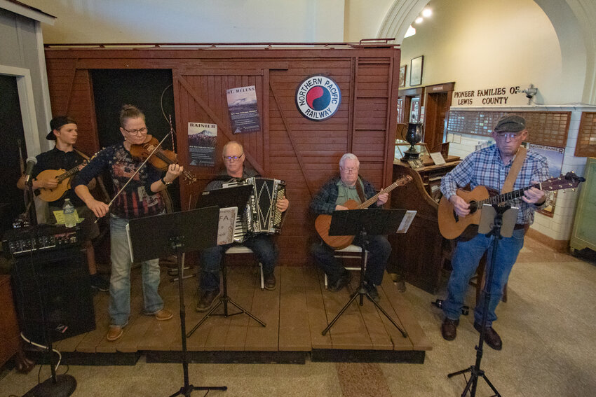 From the left, Washington Old Time Fiddlers Association members Kain Wallen, Christie Easter, Mike Turner, Flenn Palmer and Rick Sundstrom perform inside the Lewis County Historical Museum for a Lewis County Historical Society meeting on Tuesday, March 19, 2024, in Chehalis.