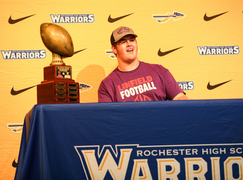Rochester's Jaden Nichols smiles after he signs a letter of intent to play football at Linfield University on Friday afternoon at Rochester High School.