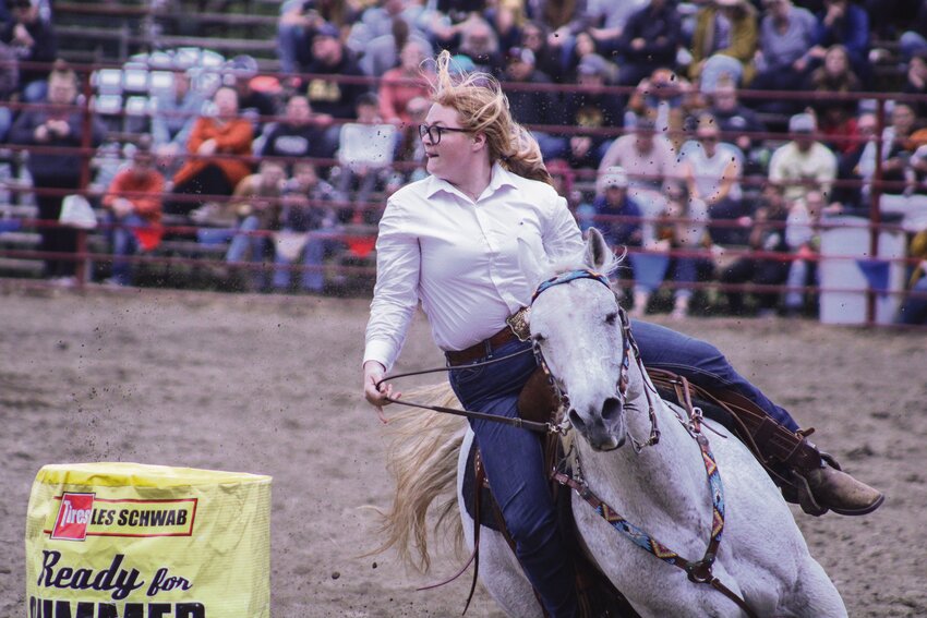 A competitor and her horse round the barrel during the barrel races at the Roy Rodeo on June 1.