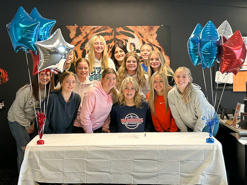 The Napavine girls basketball team smiles with Keira O'Neill (sitting middle) at O'Neill's signing ceremony at Napavine High School on June 4.