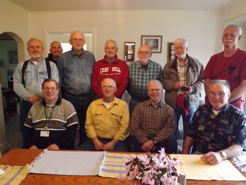 This photo from Jim Holding&rsquo;s retirement party was provided by Love INC. Holding is on the right, sitting, with the blue button-up shirt.