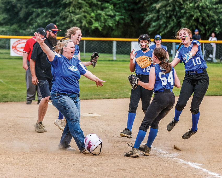 North Clark Little League&rsquo;s majors softball team players and coaches celebrate their Washington Little League Softball District 6 championship at La Center&rsquo;s Holley Park on Wednesday, June 26. North Clark took down Battle Ground 11-4.