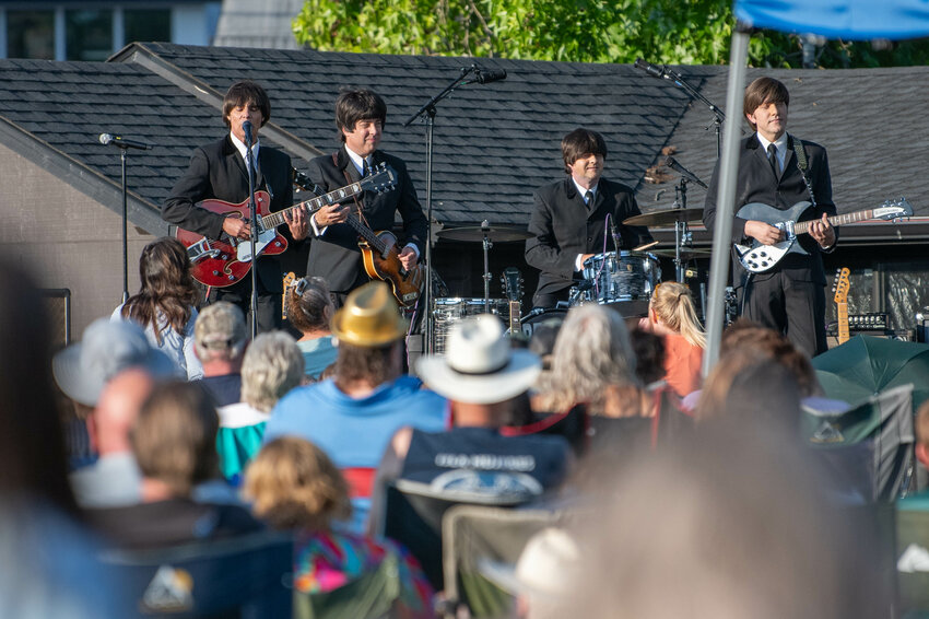 Abbey Road, a Beatles tribute band, performs at Recreation Park during Chehalis Music in the Park on Friday, July 26. Abbey Road, a Beatles tribute band, played hits from the classic British music icons in a &ldquo;battle of the bands&rdquo; style performance with Rolling Stones tribute band Jumpin&rsquo; Jack Flash, which have been touring together since 2011. The free concert at Recreation Park drew a large crowd. It was the second concert in the summer series. The final free concert, on Aug. 2, will feature Gretchen Peters performing along with local Randy Linder, who will perform as the opening act. It begins at 7 p.m.