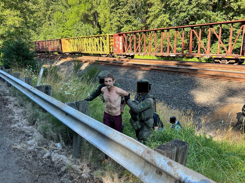 Steven L. Messex is taken into custody Thursday afternoon in this photo provided by Thurston County Sheriff Derek Sanders. The faces of officers have been obscured in the image.