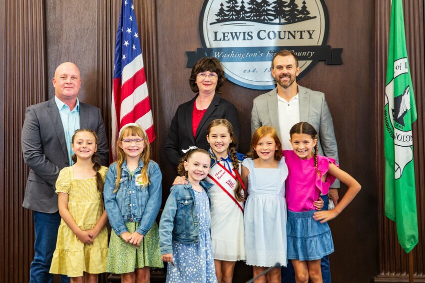 Little Miss friendly finalists pose with Commissioners Scott Brummer, Lindsey Pollock and Sean Swope during a Lewis County commissioners meeting at the Lewis County Courthouse on Tuesday, Aug. 6. From left in the front row are Justice Barton, Avery Butler, Hadleigh Westover, current Little Miss Friendly Clara Hansen, Kimber Serl and Avery Mordick.
