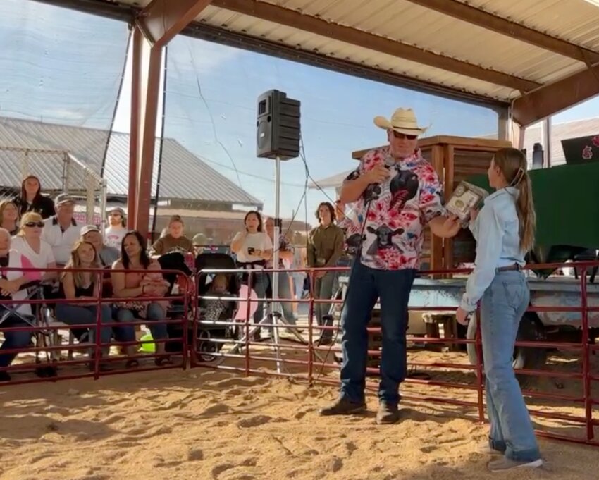 Southwest Washington Junior Livestock Sale Committee member Jason Humphrey names Kennedy Kinsman of Onalaska the Hay Queen of this year's Junior Livestock Sale on Friday, Aug. 16, at the Southwest Washington Fair just before kicking off the livestock auction.