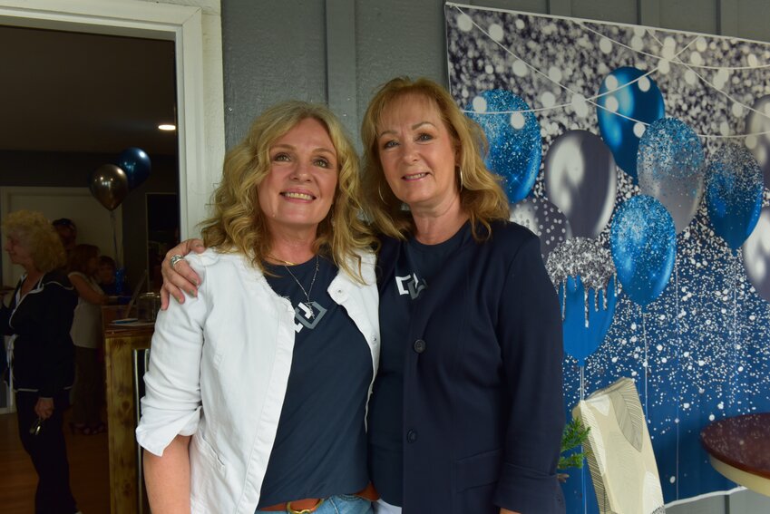 Holly Kappert (left) and Terry Kaminski (right) smile on Thursday, Aug. 15, at Windermere Real Estate's ribbon-cutting ceremony.