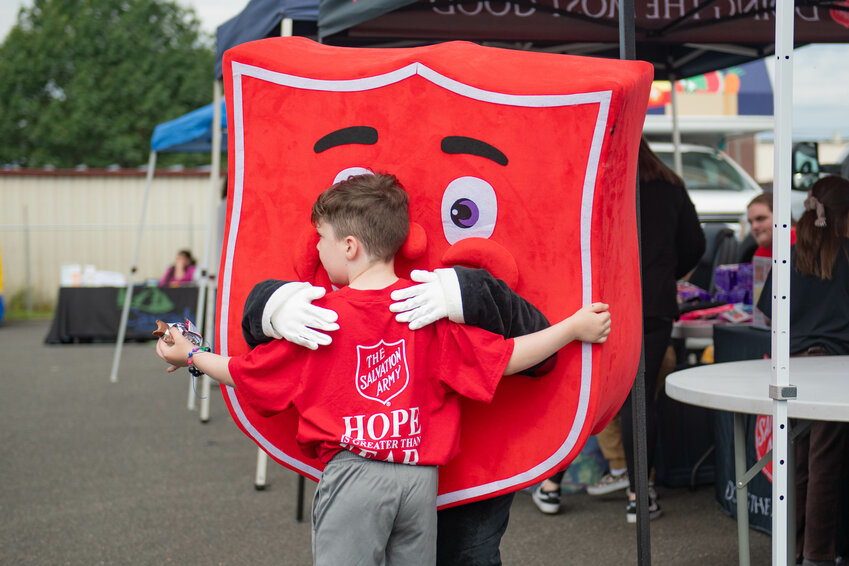 The Salvation Army mascot gives a hug during a recourse fair at the Salvation Army in Centralia on Monday, Aug. 26.