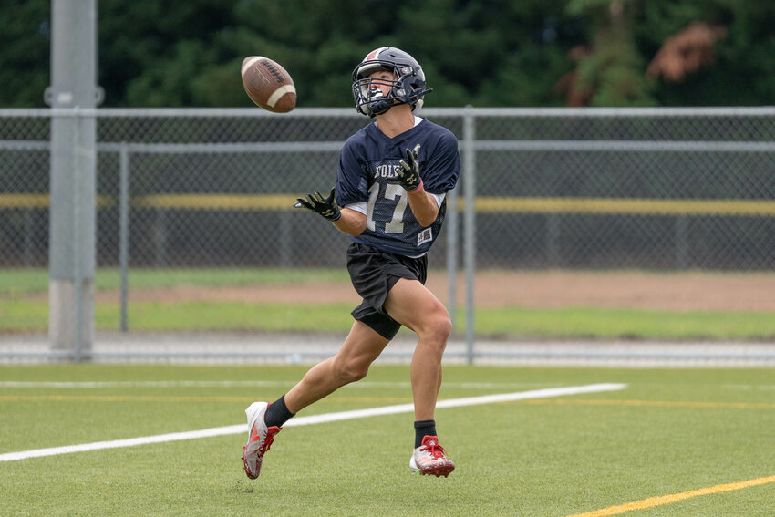 Wolves receivers catch passes during a preseason football practice at Black Hills High School on Thursday, Aug. 22.