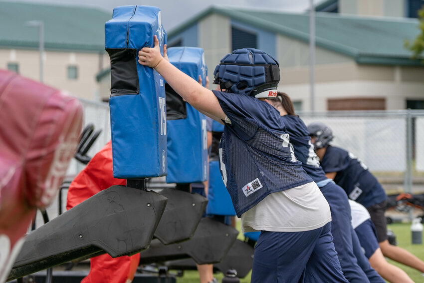 Wolves lineman push a sled during a preseason football practice at Black Hills High School on Thursday, Aug. 22.