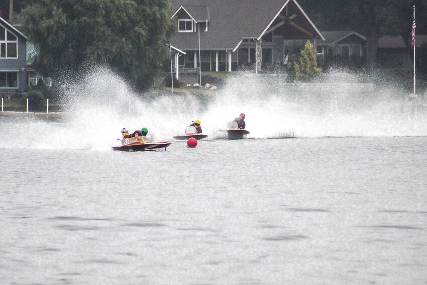 Zach Malhiot carries his daughter Amelia out of her boat after a race at Lake Lawrence on Sept. 15.