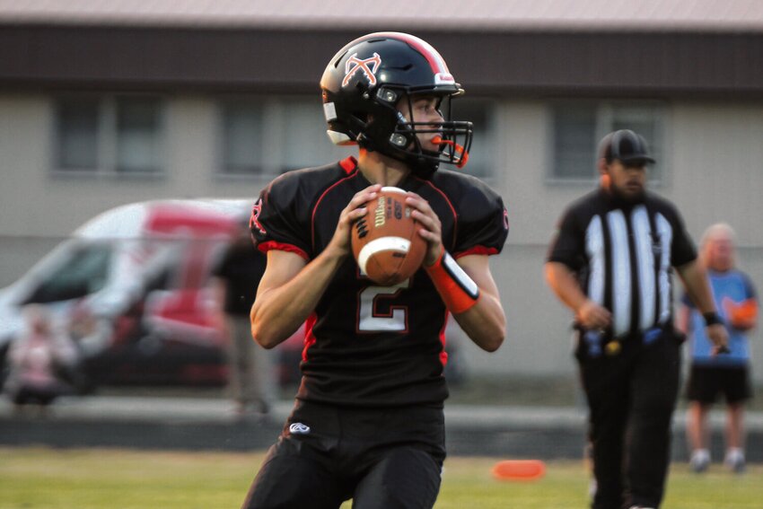 Rainier quarterback Jake Meldrum scans the field in the team's season opener against Tenino on Sept. 6.