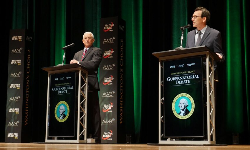 Former congressman Dave Reichert, a Republican, left, and Washington state Attorney General Bob Ferguson, a Democrat, right, are seen on stage during the second debate of the 2024 Washington state governor’s race, Sept. 18, 2024, in Spokane, Wash.