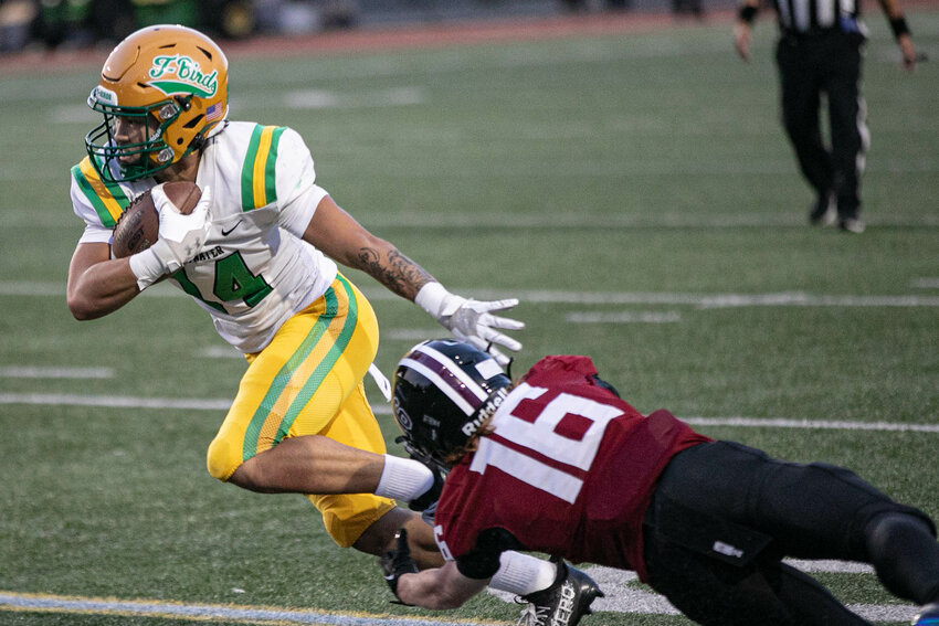 Tumwater's Sunny Nguyen catches the ball and evades a tackle by Eastlake's Chase Dannemiller in a Week 3 non-league game on Thursday, Sept. 19 at Eastlake High School.