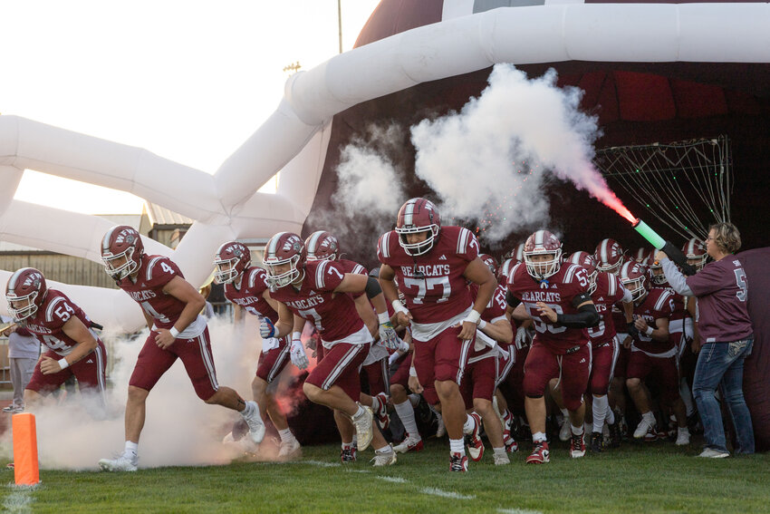 W.F. West players run out of an inflatable helmet before a football game against Timberline at W.F. West High School on Friday, Sept. 20.