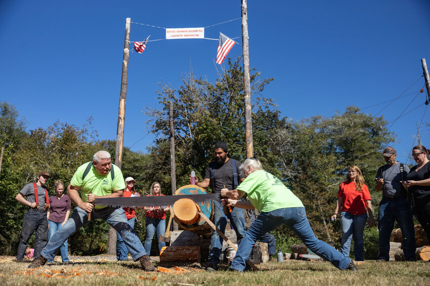 Mike and Martha Nichols compete in Ma and Pa bucking during the annual Saginaw Days Logging Show at the Brooklyn Tavern on Saturday, Sept. 21. Each team, made up of one male and female, sawed through the log with a timer going until the sawed-off end hit the ground.