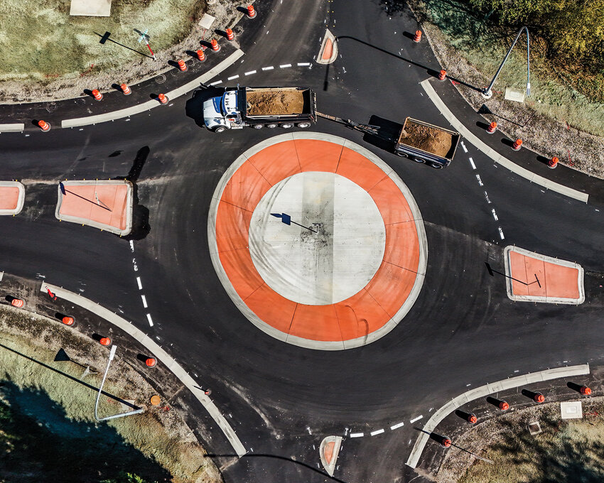 In a five-minute period, 11 rock trucks traveling north and south along state Route 503 traversed the new roundabout at the intersection with Northeast Rock Creek Road without driving significantly over the dividing piece or having a harder time getting up to speed in the afternoon on Thursday, Sept. 26.