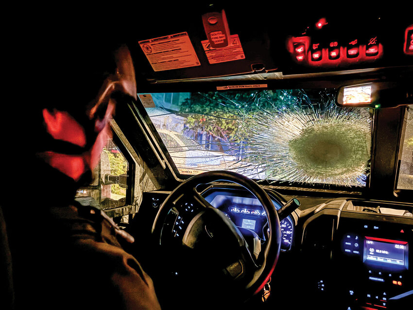 A Southwest Washington Regional Special Weapons and Tactics (SWAT) Team officer from the Vancouver Police Department sits in a SWAT armored vehicle after a suspect fired a high-powered rifle shot that struck the windshield during a disturbance that started Thursday, Sept. 26, and ended before 3 a.m. Friday in the 5400 block of Northeast 71st Street in Vancouver. The suspect was killed during the incident.