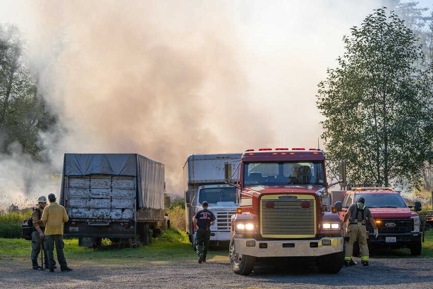 The Washington Department of Natural Resources assists Lewis County firefighters in responding to a brush fire off of Beaver Creek Road in Boistfort on Thursday, Oct. 3, 2024.