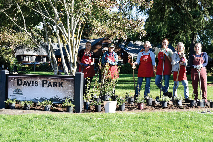 Ridgefield Garden Club members clear the flower beds in Davis Park to make space for native plants. They planted about 20 native species last week to support pollinators.