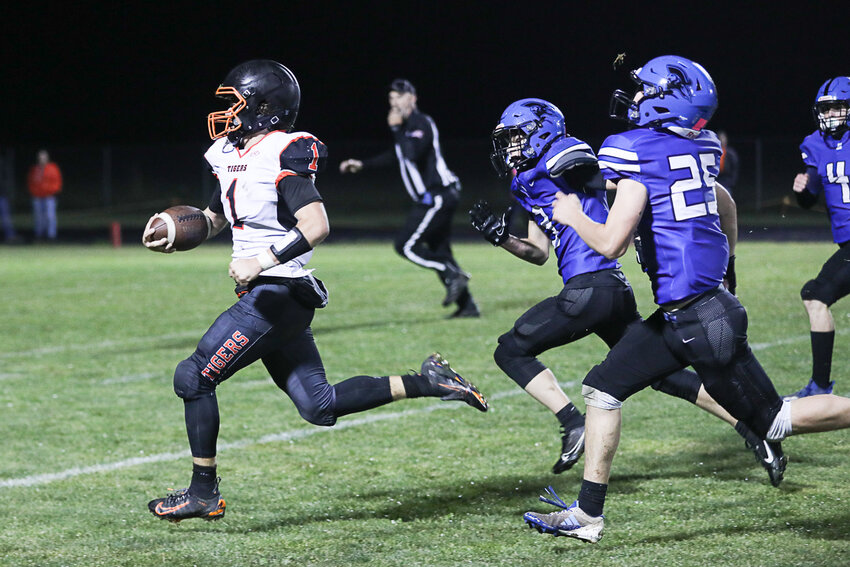 Napavine's Grady Wilson races past a pair of Adna defenders during Napavine's win over Adna on Oct. 4.