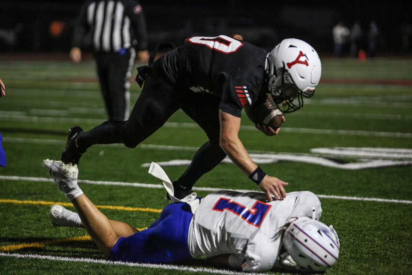 Yelm quarterback Parker Myers is tackled low by Graham-Kapowsin defensive back Dominic-Jedidiha Taape on Oct. 4.