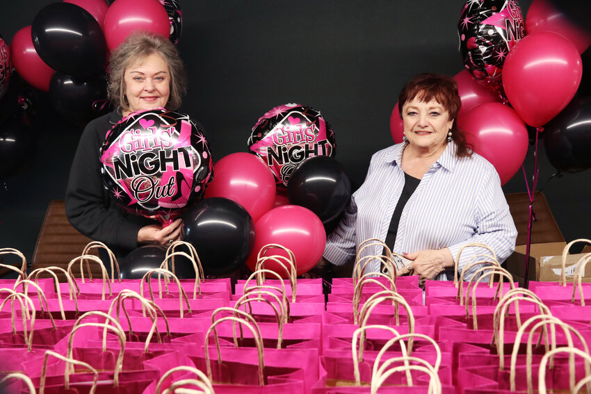 Girls Night Out organizers Sandy Walczyk, left, and Flossy Heymann pose for a photo with the gift bags and balloons they prepared at The Station in Centralia on Friday, Oct. 4, ahead of the 35th Girls Night Out event on Saturday.