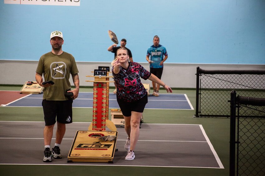 Caleb Howell, left, and Jay Stumpf, right, compete in the American Cornhole League Interstate Championships at 23 Kitchens in Lacey on Oct. 5.