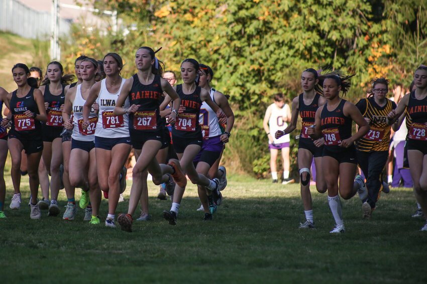 Madison Ingram, with Komaire Robles right behind her, finishes in first place at the Rainier Invitational at Rainier Elementary School on Oct. 10.