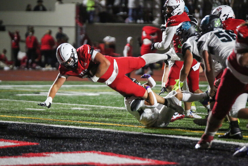 The Yelm Tornados defense celebrates after Ethan Owens, 22, forces and recovers a fumble against Bonney Lake on Oct. 11.