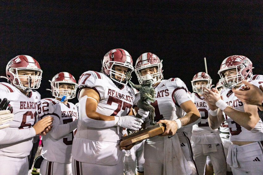 W.F. West quarterback Gage Brumfield and Carlos Vallejo hold the Swamp Cup trophy after defeating Centralia at Centralia High School on Friday, Oct. 18.