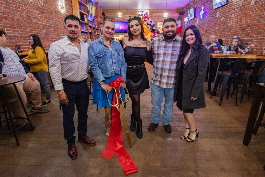 From the left, members of the Martinez-Torrecillas family Juan Martinez Sr., Lizeth Torrecillas, Yeira Martinez, Juan Martinez Jr. and Alicia Martinez pose for a photo after the grand opening and ribbon cutting for the family's new business JJ's Sports Bar on Friday, Oct. 18, in downtown Centralia.