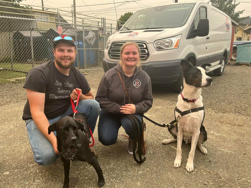 Kalvyn and Morgan Scott pose with Diesel and Cosmo on the day they adopted Cosmo in September 2022.