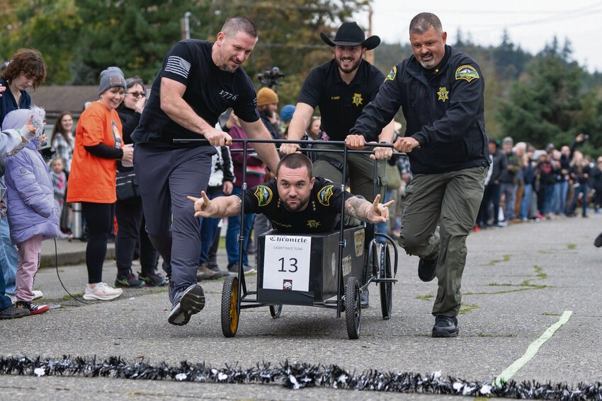 The Thurston County Economic Development Council team races its casket to the finish line during the annual Boo-coda casket races in Bucoda on Saturday, Oct. 19.