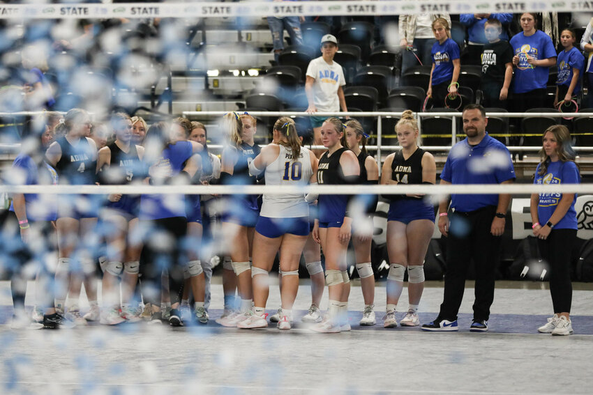 As confetti falls, the Adna volleyball team watches on as Manson is presented the 2B State Championship Trophy after the 2B State Championship game at the Yakima SunDome on Nov. 14.