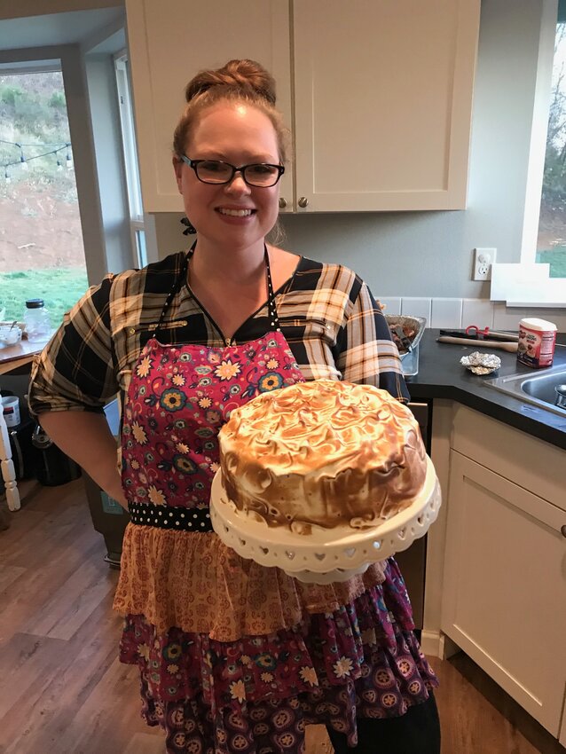 Jenni Guajardo holds her show-stopping Pumpkin S&rsquo;mores Layer Cake that she first found the recipe for in a magazine in 2017 or 2018 and has crafted for each Thanksgiving since
